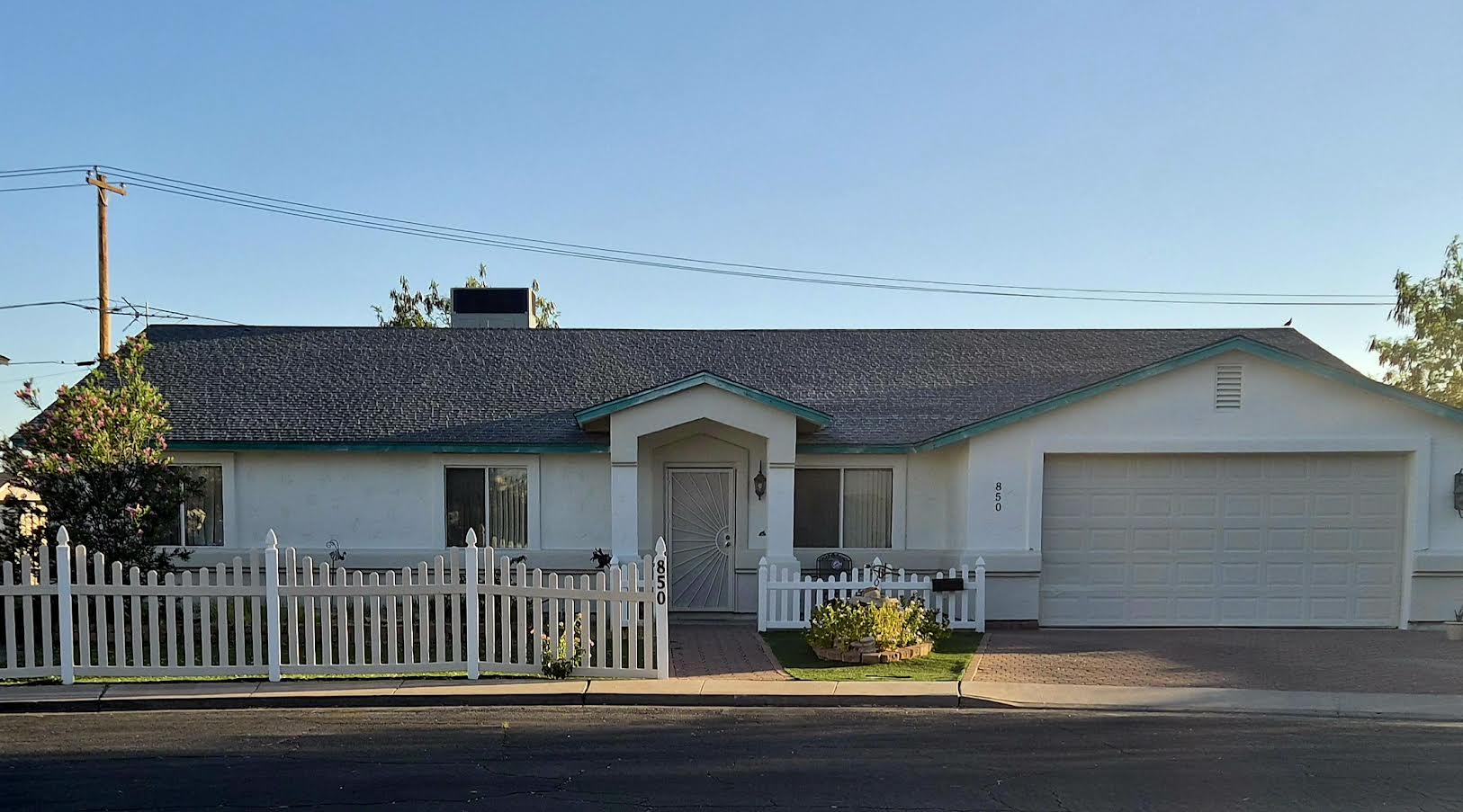 Charming vintage venue exterior with white picket fence in Mesa AZ